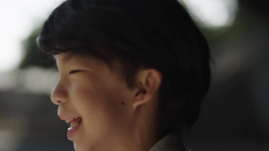 The boy smiles and walks away