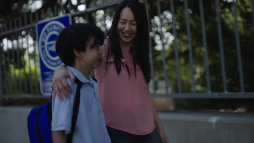 A mother is walking her son to school