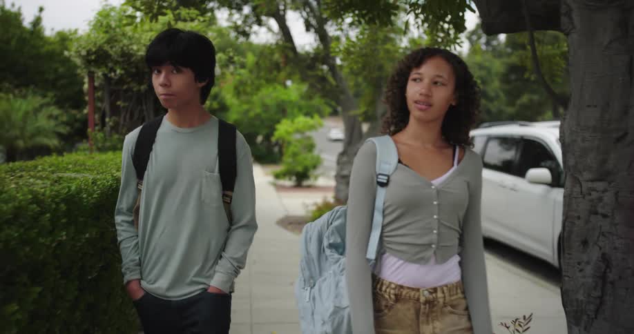 Friends walking on a suburban sidewalk