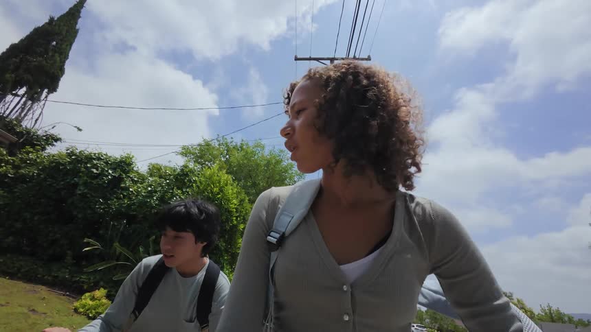 Two teenagers briskly walking outdoors