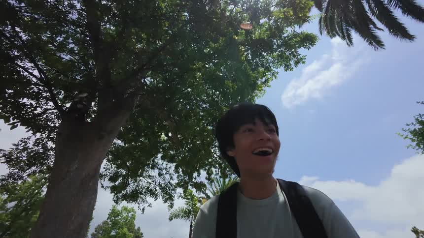 Boy with a happy expression walking quickly through an urban neighborhood