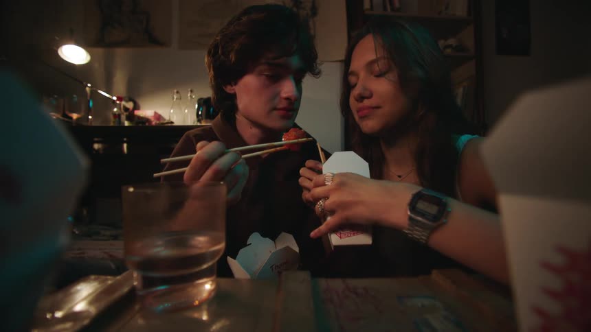 A young couple kisses on a dinner date