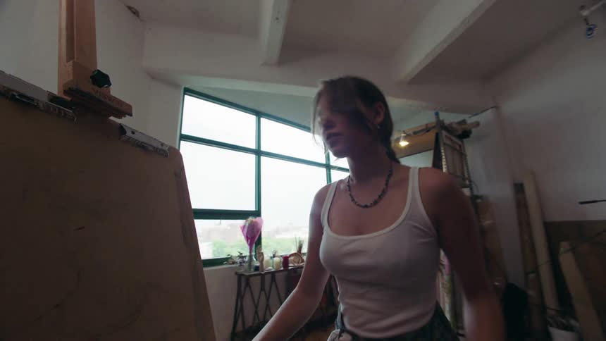 The artist puts paper on the canvas