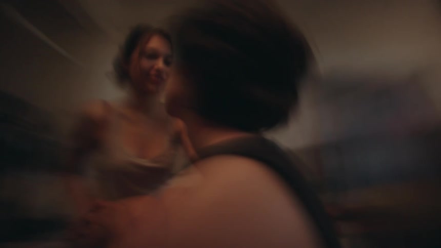 Couple in an indoor space exchanging caresses