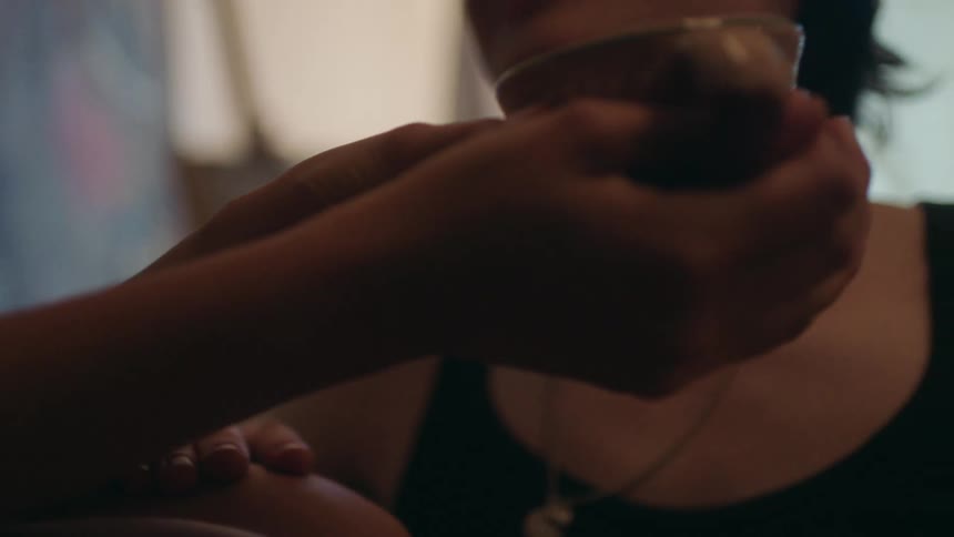 Man talking to a person next to him who is holding a mug
