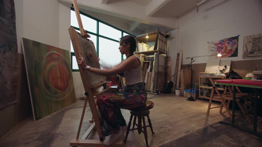 Woman artist drawing on a board