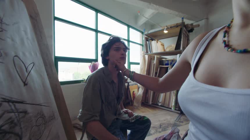 Woman with happy expression drawing a man next to her