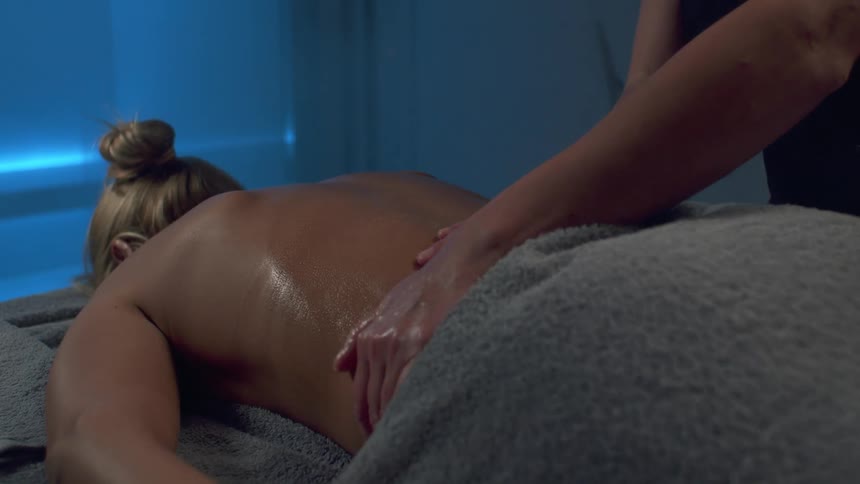 A woman is getting a massage with oil
