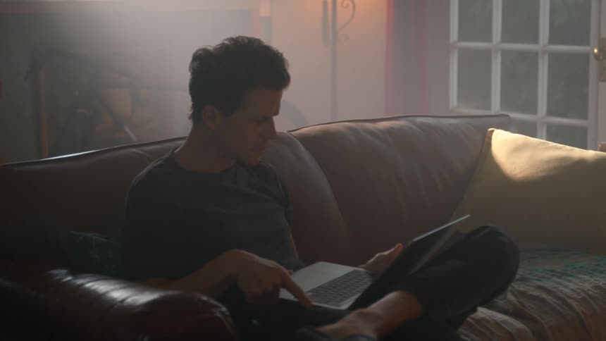 Man working on laptop in cozy home setting