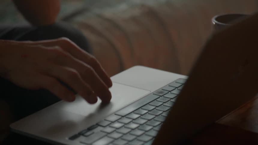 Pair of hands typing on a laptop