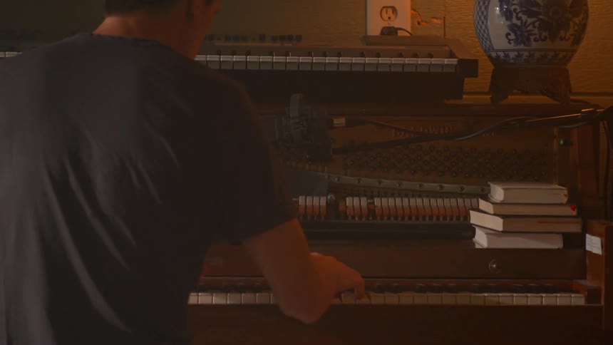 Person playing piano in a home music studio