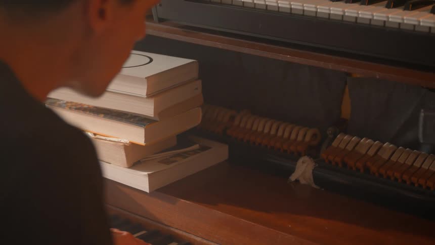 A man sits and plays the piano