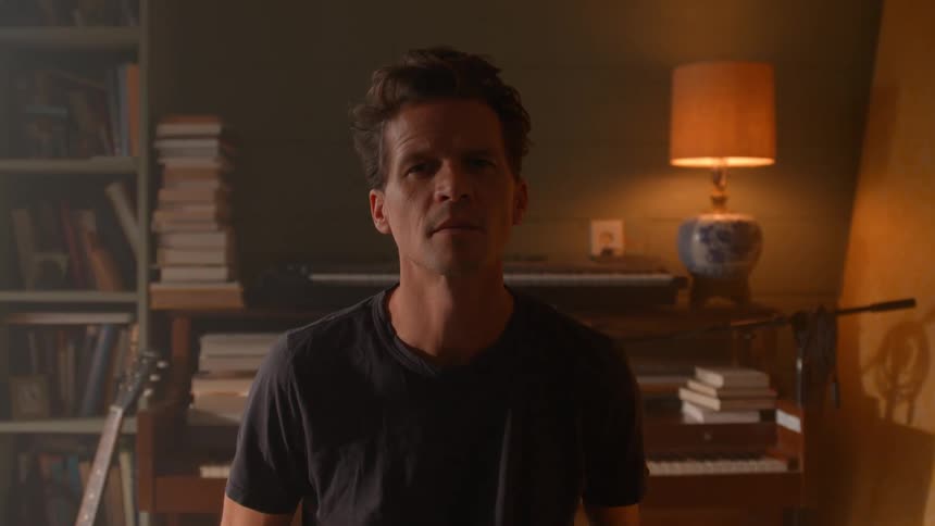 Portrait of a young man in a living room during daytime