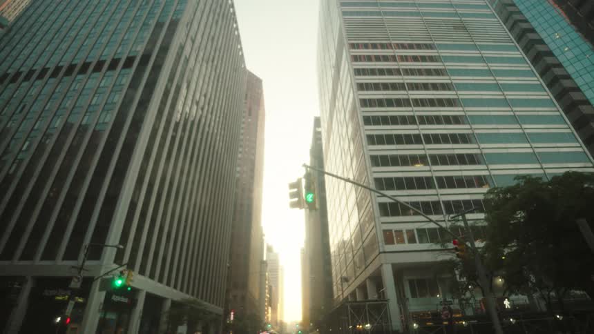 A bus passes by the tall buildings