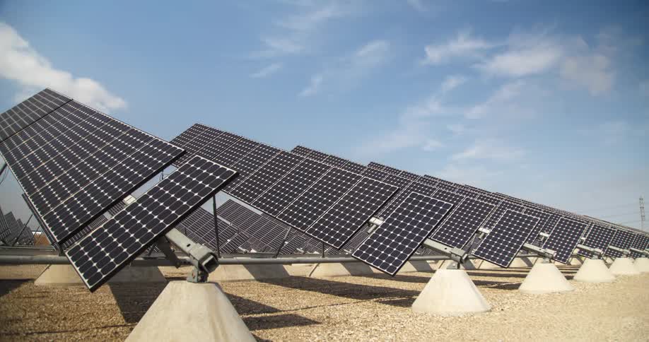 Solar panels arranged on a solar farm outdoors during daytime