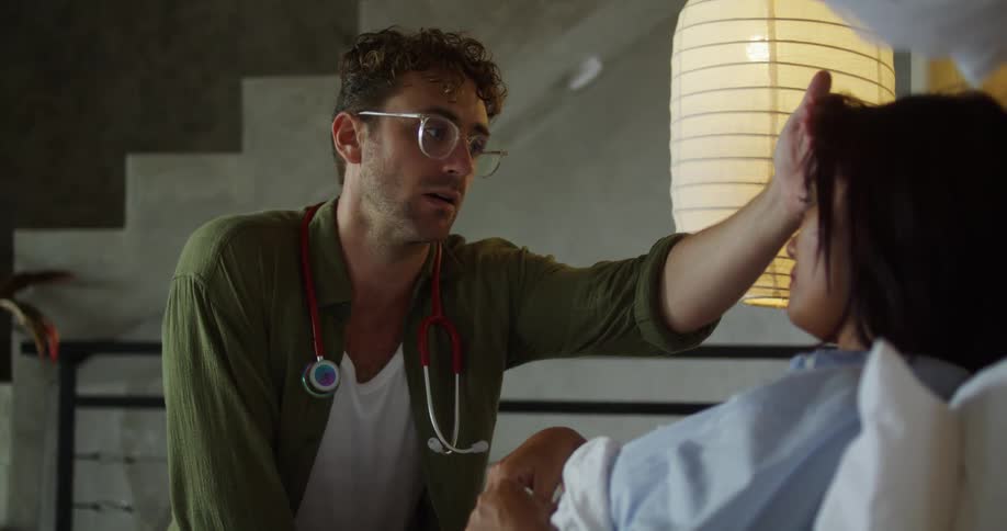 Doctor checking the fever of a lying patient