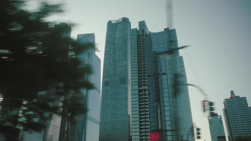 A city center with several skyscrapers full of glass windows