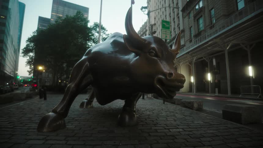 Bronze bull in a square in front of a building