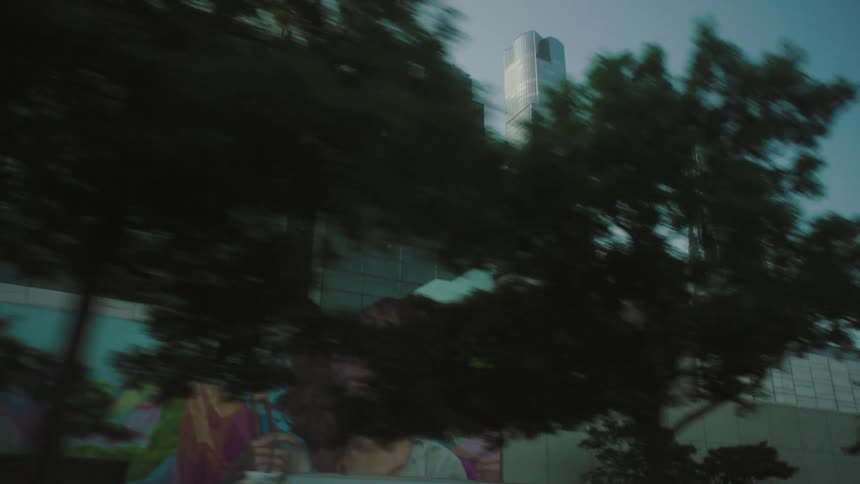 Traffic runs by the tall buildings