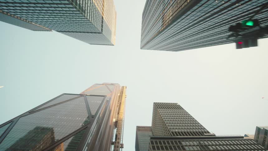 Upward view of tall modern skyscrapers against a clear sky
