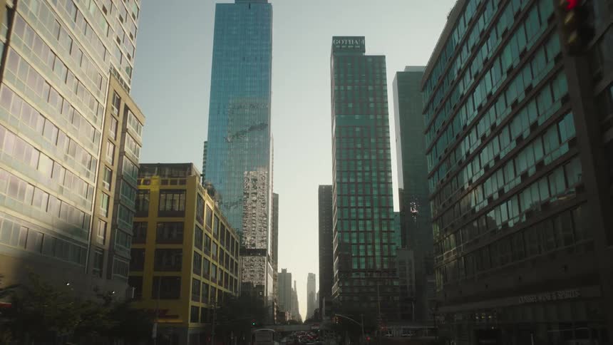 A city skyline view with a series of skyscraper buildings at sunset