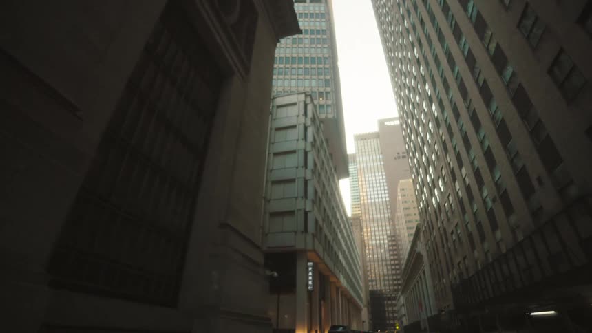 A city street view with a series of highrise and skyscraper buildings at midday