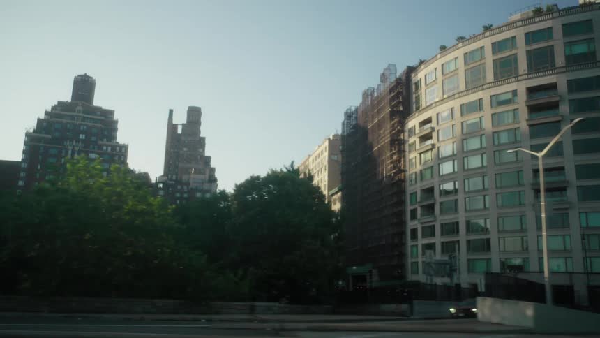 Urban and residential buildings on the edge of an overpass with vehicle traffic