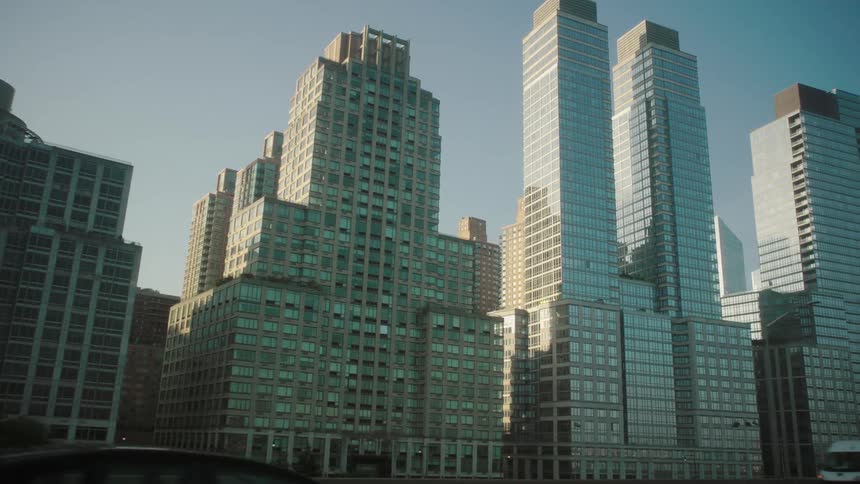 The sun reflects off the tall skyline