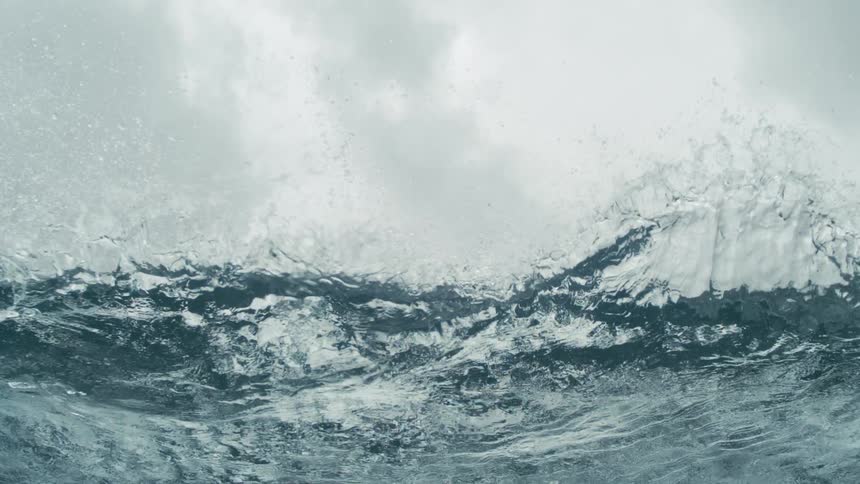 A wave breaking its crest on its surface and making a splash forward