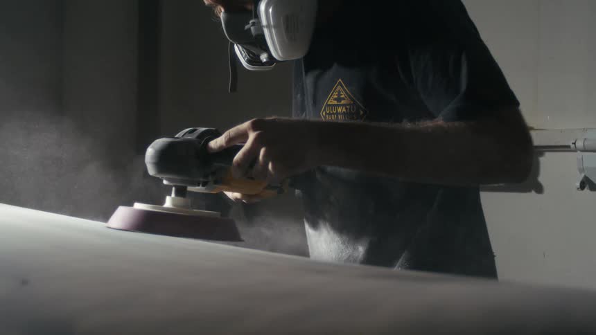 A person sands an object