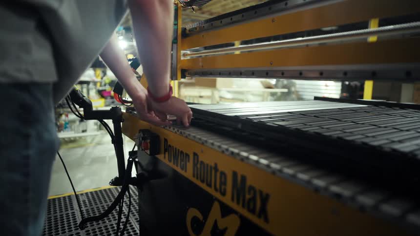 Pair of hands handling a tool on an industrial machine