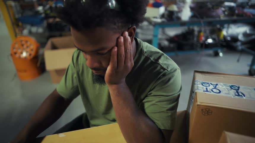 Man sitting with his hand on his head