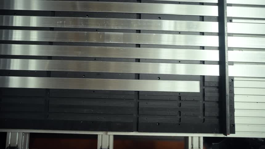 Horizontal metal and black wooden panels cover a modern wall structure