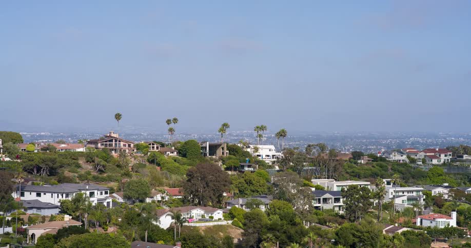 Suburb sits on top of a hill in front of a sprawling city