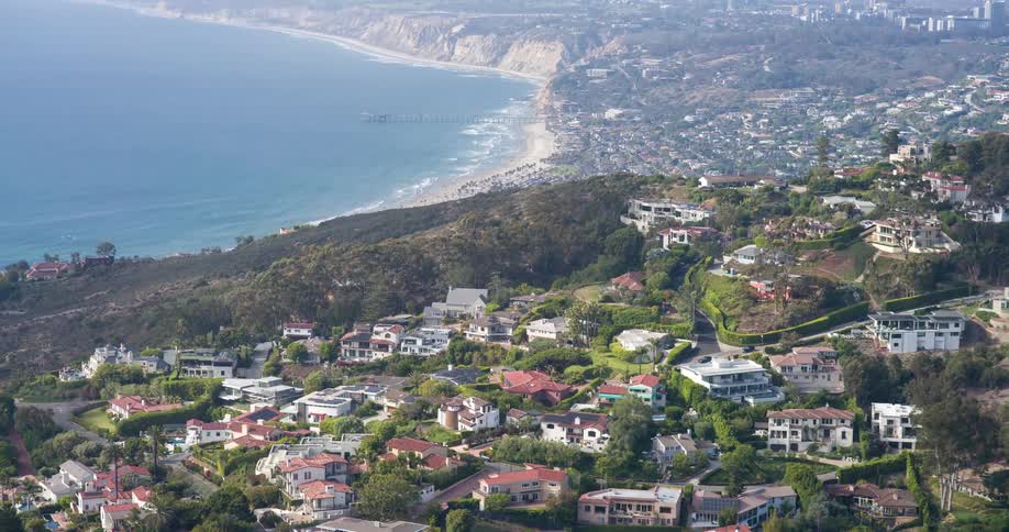 Urban city in the mountains with the beach in the background