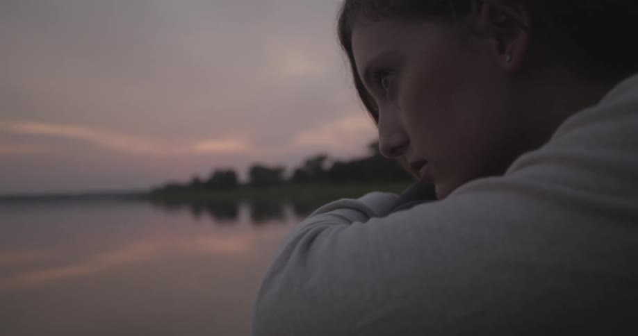A woman looks out over the water