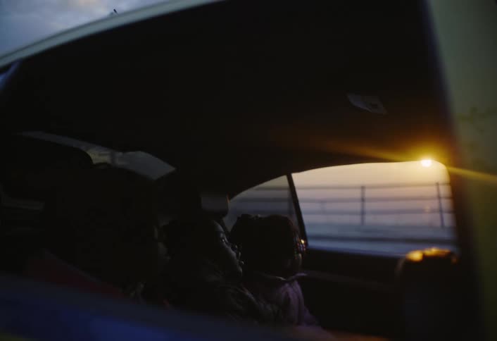 Children are sitting in the backseat of the car