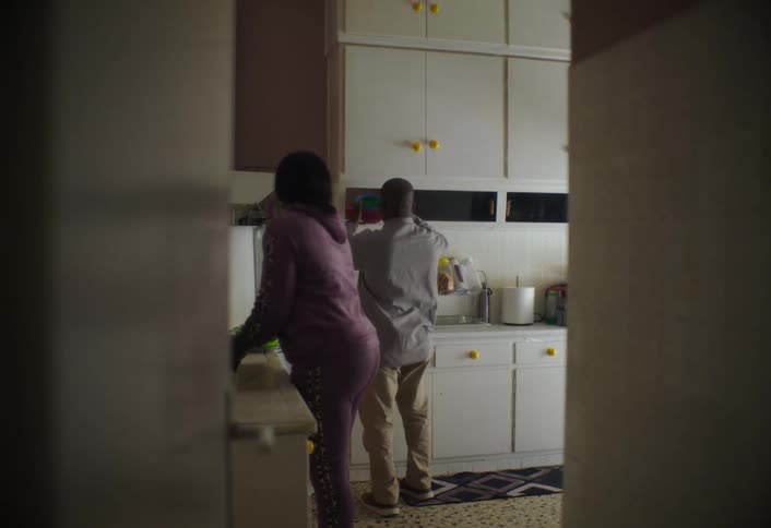 A man and woman are in the kitchen together