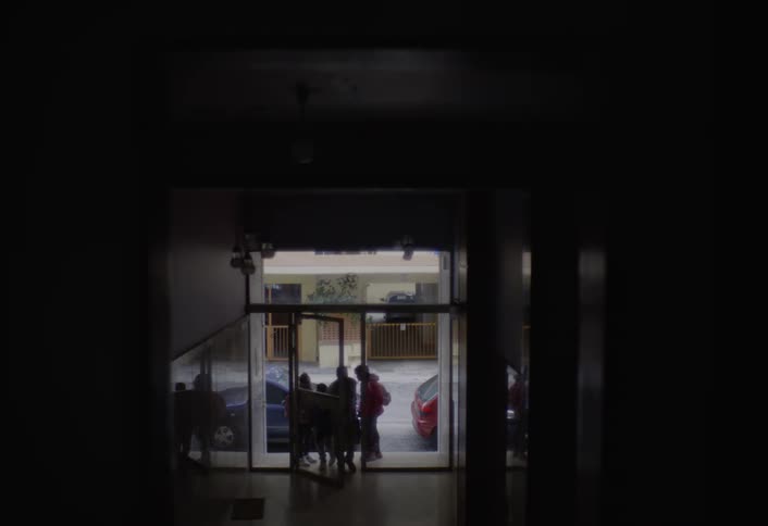 Silhouette of people entering a building