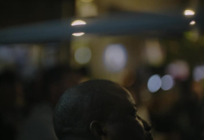 A man is standing by a group at night