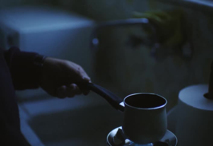 Man heating coffee on the stove