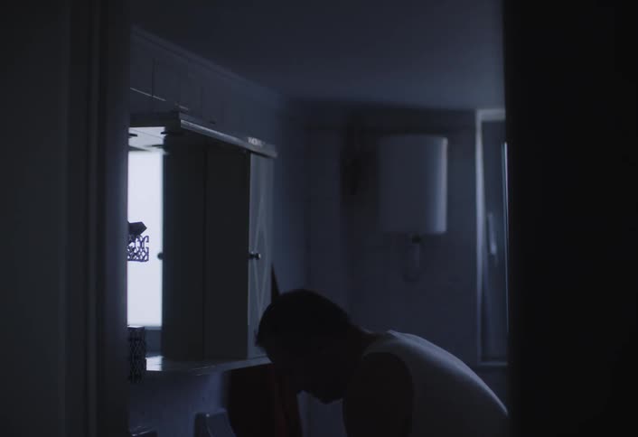 Man entering and washing his face in the bathroom