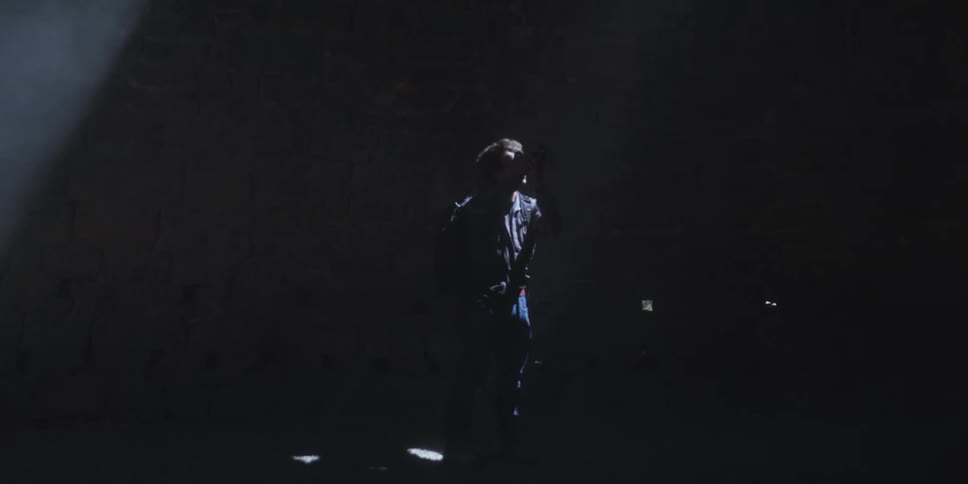 A man is taking pictures in the dark area