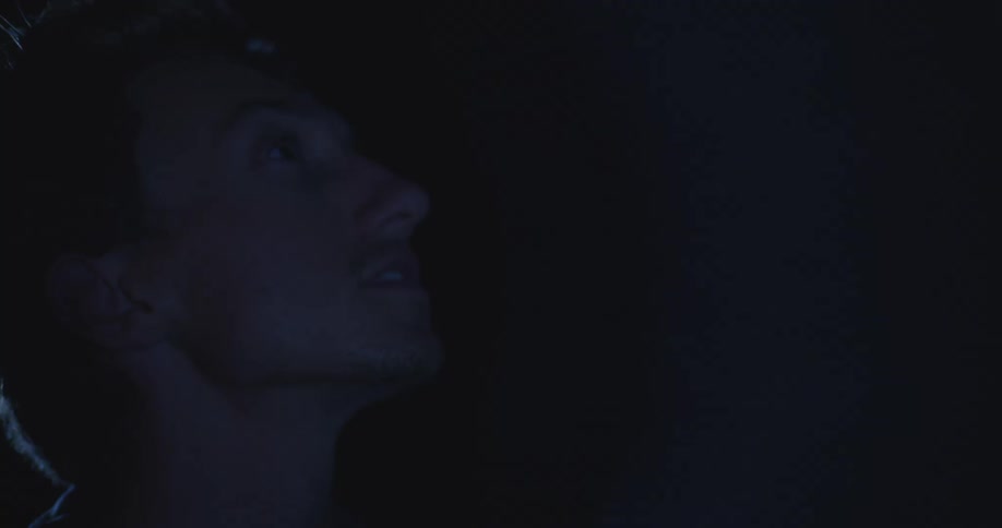 A man searches around in the dark