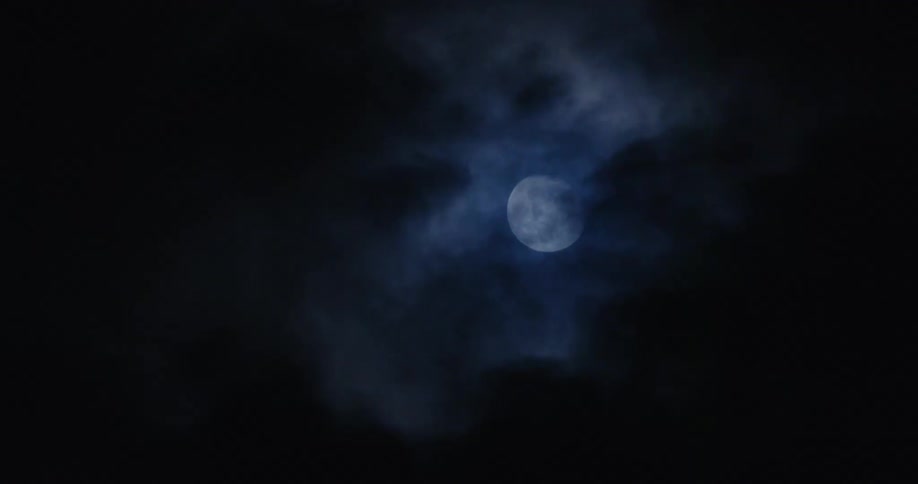 Clouds pass in front of the moon