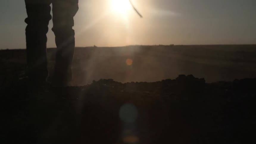 A person walking against the horizon