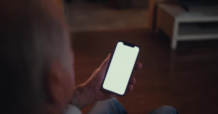 A man holding a smartphone with a blank screen