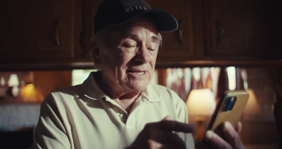 Elderly man happily talks during a video call