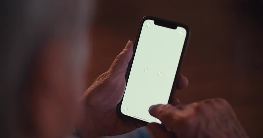 The video features a closeup of hands operating a smartphone with a green screen indicating the potential for a customizable display the users fingers are visible tapping and swiping on the screen highlighting the interactive nature of the device