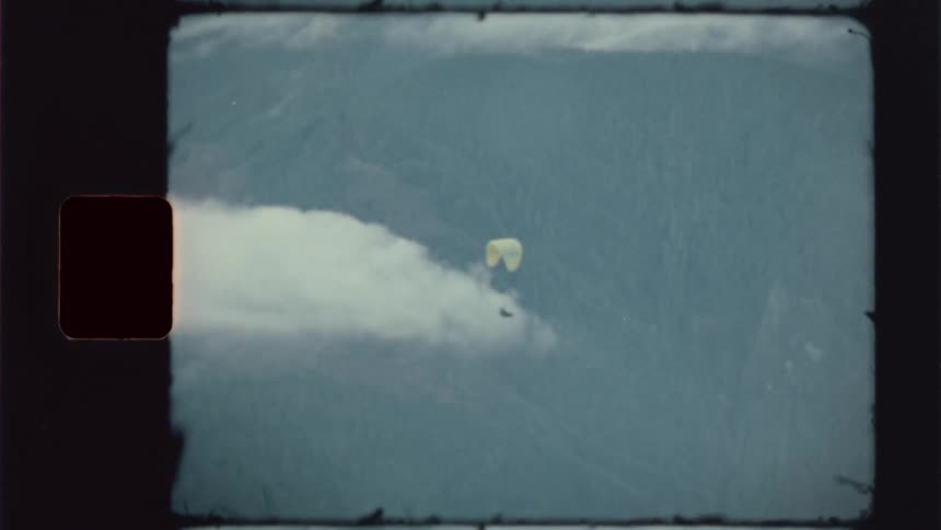 Person parachuting in a place surrounded by mountains